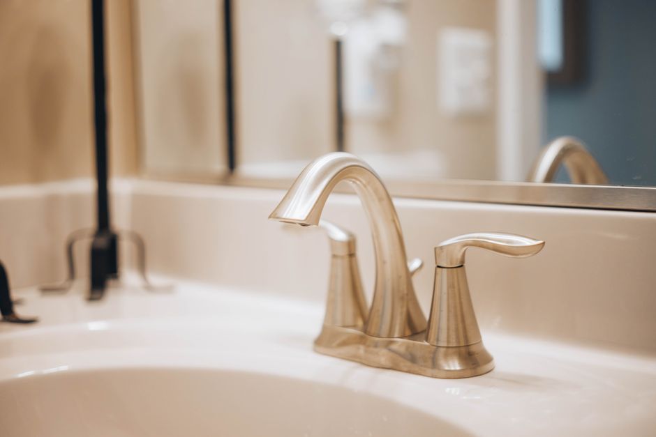 New brushed-nickel faucet installed on a bathroom sink